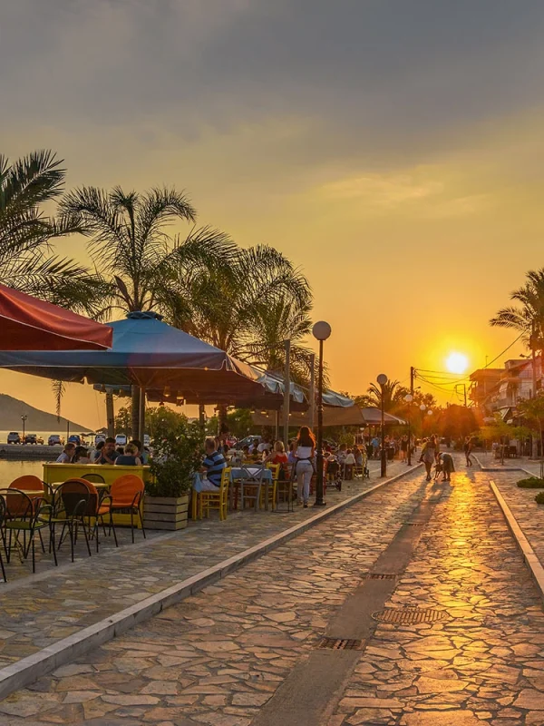 Bustling pedestrian street in Gialova, lined with an array of local boutiques, cafes, and eateries, offering a lively atmosphere for leisurely strolls and authentic Greek dining experiences.